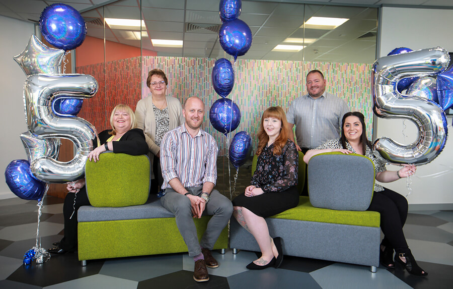 Staff with 5 year balloons